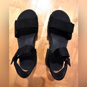 Black UGG sandals. Lug sole and adjustable neoprene ankle and foot straps